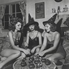 three women in witches hats sitting on a couch