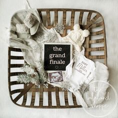 the grand finale is displayed on a wicker basket with baby's clothes