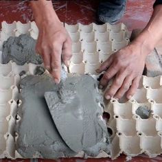 a person is working with cement on the floor