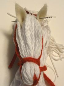 the yarn is white and red, but it looks like an animal's tail