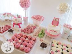 a table topped with lots of cupcakes and cakes