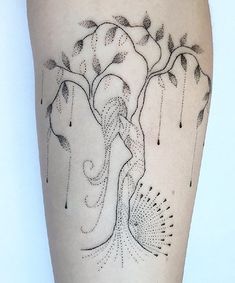 a woman's leg with a tree and dots on the lower part of her thigh