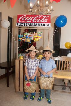 two young boys standing next to each other holding baskets