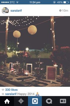 an image of a table set up for a party with lights and decorations on it