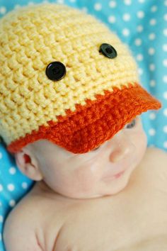 a close up of a baby wearing a hat