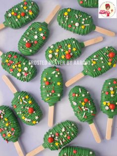 there are many green desserts on sticks with stars and snowflakes all over them