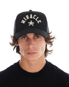 BLACK CANVAS TRUCKER HAT WITH PLAYERS MOTIF ON FRONT 57% COTTON 43% NYLON MIRACLE STAR MOTIF EMBROIDERED ON FRONT ADJUSTABLE SNAP CLOSURE ONE SIZE FITS MOST Black Baseball Cap With Letter Print, Black Curved Brim Trucker Hat For Winter, Black Trucker Hat For Winter, Star Motif, Black Canvas, Snap Closure, Trucker Hat, Stars, Hats