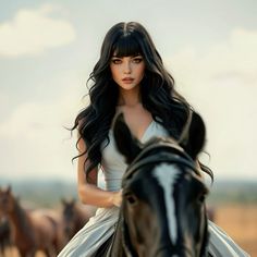 a woman riding on the back of a black horse