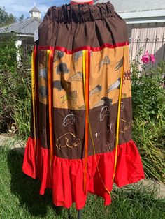 Brown over buffalo print ribbon skirt with red ruffle, lots of float ribbons, the embroidery isvpictographs of hunting scenes! This skirt has lots of flare. paper bag elastic waistline 28-42", length 35", side pockets. Native American Ribbon Skirts Pattern, Native American Ribbon Skirts, Ribbon Skirts Pattern, Skirts Pattern, Ribbon Skirt, Buffalo Print, Hunt Scene, Ribbon Skirts, Womens Skirts