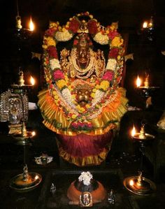 an idol is surrounded by candles and other items