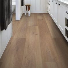 a kitchen with wood floors and white cabinets