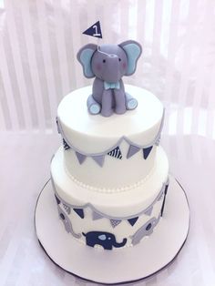 a three tiered cake with an elephant on top