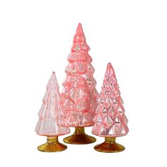 three pink glass christmas trees sitting on top of each other