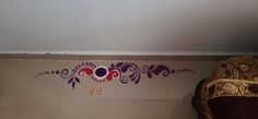 the wall is painted with purple and red designs