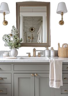 a bathroom vanity with two sinks and a large mirror above it, along with gold faucets