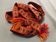 Very beautiful woolen belt in so expressive colours in geometry style! Very bright colours! Very little defect from inside part shown on photo! Multicolor Fabric Belt In Folk Style, Folk Style Multicolor Fabric Belt, Multicolor Bohemian Belt For Festivals, Folk Style Multicolor Embroidered Belt, Artisan Multicolor Fabric Belt, Multicolor Folk Fabric Belt, Folk Multicolor Embroidered Belt, Handmade Multicolor Belt For Festivals, Handmade Multicolor Belts For Festival