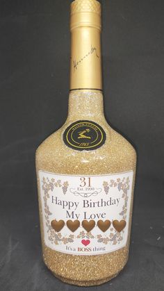 a bottle of happy birthday my love with hearts on the label and gold foiling