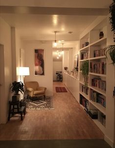 a living room filled with furniture and bookshelves