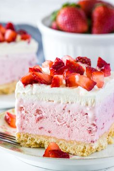 a slice of strawberry cheesecake on a plate with a fork and bowl of strawberries in the background