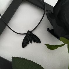 This unique black moth pendant necklace is a striking addition to your gothic jewelry collection. Made from durable materials, it perfectly captures dark elegance with its moth design. Ideal for adding a touch of mystery to any outfit or as a thoughtful gift for someone who loves gothic accessories. Perfect for Halloween, dark fashion, or alternative styles. *We take great care in packaging and shipping orders to ensure safe and fast delivery. However, in order to maintain affordable prices for Black Pendant Necklace For Halloween, Gothic Black Necklace For Gift, Black Witchy Necklace For Gift, Handmade Black Witchy Necklace, Moth Pendant, Moth Design, Dark Elegance, Dark Jewelry, Gothic Accessories