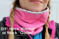 a woman wearing a pink neck warmer over her face