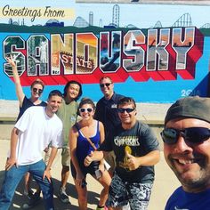 a group of people standing in front of a sign