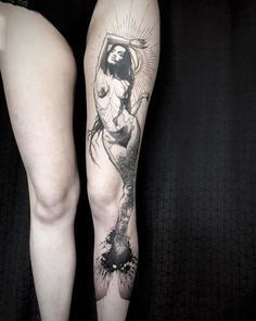 a woman's leg with a tattoo on it and an image of the virgin mary