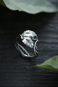 ITEM DESCRIPTION: The size  of ring 7 3/4 (US and Canada) P 1/2 (UK and AU)  I can make it any size you want - just mark your size in the order Weight - 2 g.  Absolutely stunning botanical ring with leaves. I made it of sterling silver and blue topaz. But I can make it with different gemstones. The silver leaves are very detailed and look like a piece of wild nature. This Elven ring will be a great addition to your jewelry collection or a special piece for Engagement. Ooak jewelry made by eco-fr Wedding Wire Wrapped Sterling Silver Rings, Unique Hand Forged Crystal Wedding Ring, Unique Hand-forged Crystal Wedding Ring, Nature-inspired Open Ring Wedding Jewelry, Nature-inspired Hand Forged Jewelry For Promise Ring, Hand Wrapped Sterling Silver Jewelry For Wedding, Nature-inspired Hand Forged Promise Ring, Unique Hand Wrapped Promise Ring, Sterling Silver Nature-inspired Wedding Crystal Ring