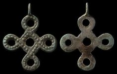 two ancient silver cross pendants on black background