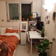 a bedroom with a bed, desk and window