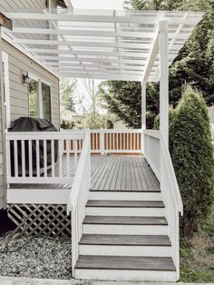 a white porch with steps leading up to it