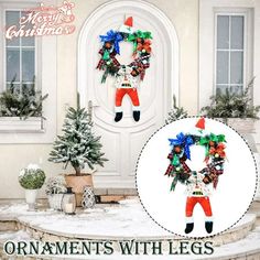 an ornament with legs is displayed in front of a christmas wreath and potted tree