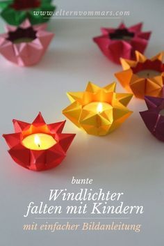 some paper cups with candles in them on a white surface and the words, bunte windlighter falten mit kindernn