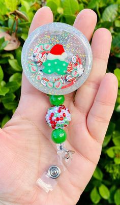 a hand holding a glass beaded christmas ornament in it's palm