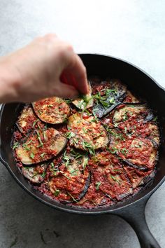 someone is cooking eggplant in a skillet