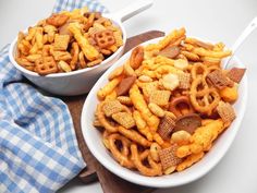 two bowls filled with cheetos sitting on top of a table