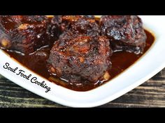 meatballs with sauce in a white dish on a wooden table and the words soul food company above it