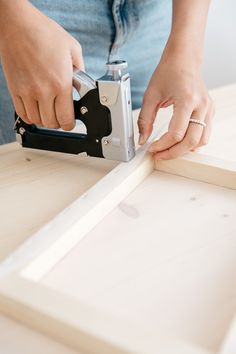 a person using a pair of scissors to cut wood planks with a jig