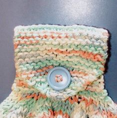 a crocheted mitten with a button on it