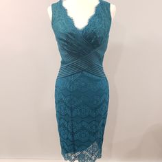 a dress on display in a room with a mannequin wearing the same outfit