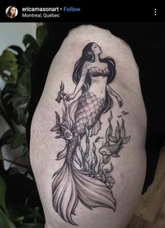 a woman with a fish tattoo on her thigh