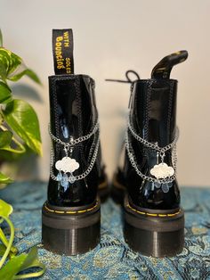 Lunar Lotus Boot Chains are the perfect way to spice up your Doc Martens or Combat Boots!  The chain length fits both Platform and Classic heel heights - Each order comes with a set of two chains of the same style - Each set is handmade. *New* Heavy Gauge Chains with detachable charms for easy mixing and matching! This Set Includes: - 2 Silver Rain Cloud Charms (Detachable) - Clips: 14mm Silver Plated - Chain: Nickle - Fittings: Silver Plated Doc Martens Decorated, Doc Martens Shoes, Doc Marten Boot, Boot Chains, Diy Chain, Closet Candy, Wrap Boots, Shoe Gallery, Rain Cloud