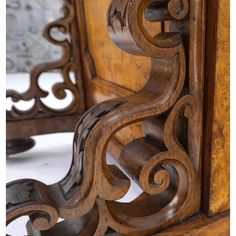 an old wooden chair with carved designs on it