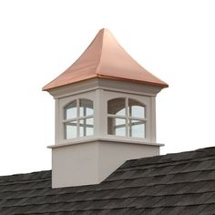 a white clock tower on top of a building with a copper roof and sky in the background