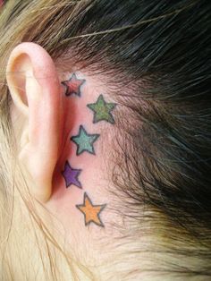 a person with a small star tattoo on their behind the ear