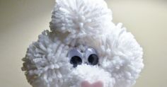 a close up of a stuffed animal with big eyes and a white fluffy coat on it's head