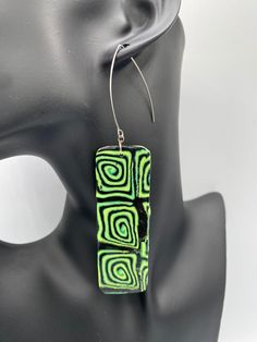 Combination of green, yellow, and black swirls polymer clay earrings   Slight variants or imperfections may differ in color and details due to the nature of handcrafting.   Polymer Clay Length: 4.5" Width: 1"  Hypoallergenic posts Silver hook Wipe Clean Made in USA Handmade  Warning Choking Hazards Green Hand Painted Drop Earrings, Artistic Green Earrings For Gift, Hand Painted Green Earrings In Polymer Clay, Hand Painted Green Polymer Clay Earrings, Green Hand-painted Polymer Clay Earrings, Green Hand Painted Polymer Clay Earrings, Black Spiral Earrings For Gift, Black Spiral Earrings As Gift, Unique Green Pierced Earrings