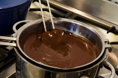 chocolate being stirred in a saucepan on the stove