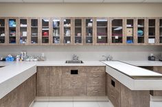 a large kitchen with wooden cabinets and white counter tops