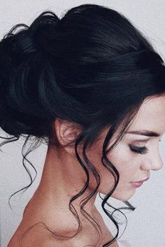 a woman with her hair in a low bun